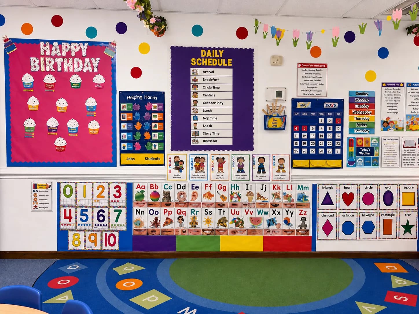 Pre-K classroom wall with daily schedule, calendar, alphabet, number, color, and shape learning materials
